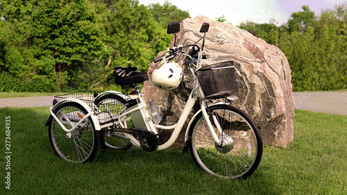 Electric bicycle on the green grass with stone background on sunny summer day. Shot from the side. A lot of natural lighting. The view of the e motor, power battery gear, hamlet and gloves.