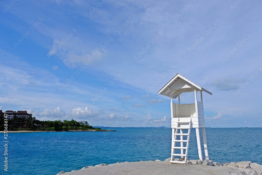 Little wooden white life guard tower at the sea on right of frame seeing the other island at a far,  Khao Laem Ya–Mu Ko Samet National Park, Rayong province, Thailand.