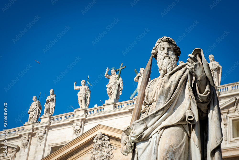 Obraz premium Vatican City - APRIL 17, 2019: Statue of Apostle Paul in front of the St Peter's Basilica. Renaissance sculpture of the Apostle Paul with a sword in sunlight..