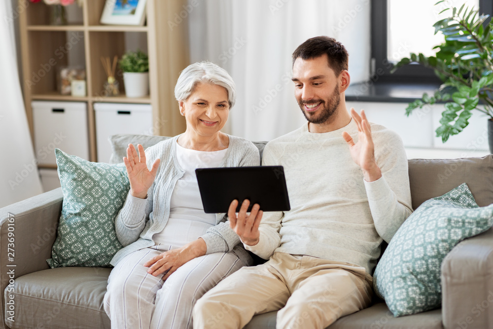 family, generation and people concept - happy smiling senior mother and adult son having video chat on tablet computer at home family, generation and people concept - happy smiling senior mother and adult son having video chat on tablet computer at home