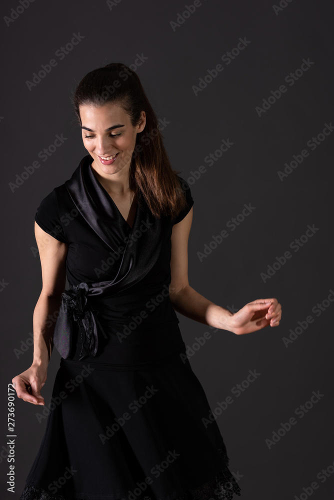 A smiling young woman dancing in the studio A smiling young woman dancing in the studio
