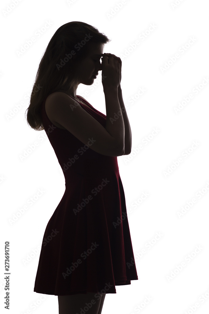 profile silhouette of a young upset woman, the girl leans her hand on her forehead and thinks about problems, the concept of difficult life situations, depression