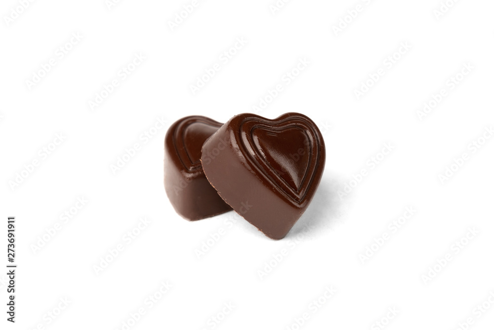 Two chocolate sweets in heart shape isolated on white background. Two chocolate sweets in heart shape isolated on white background.