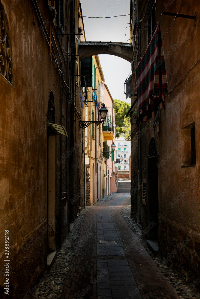 Picturesque narrow alley in Albenga, italy.