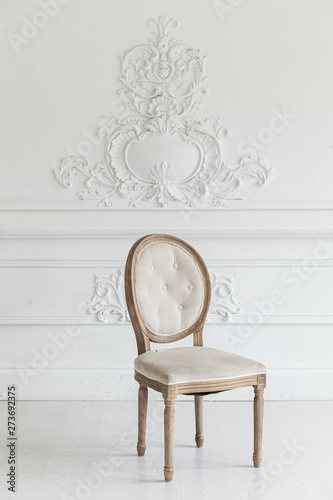 Wallpaper Mural Living room in antique style. Vintage chair against the wall with a bas-relief of plaster stucco. Selective focus. Torontodigital.ca