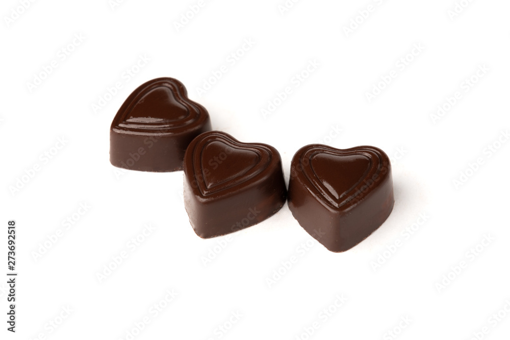 Three chocolate sweets in heart shape isolated on white background. Three chocolate sweets in heart shape isolated on white background.