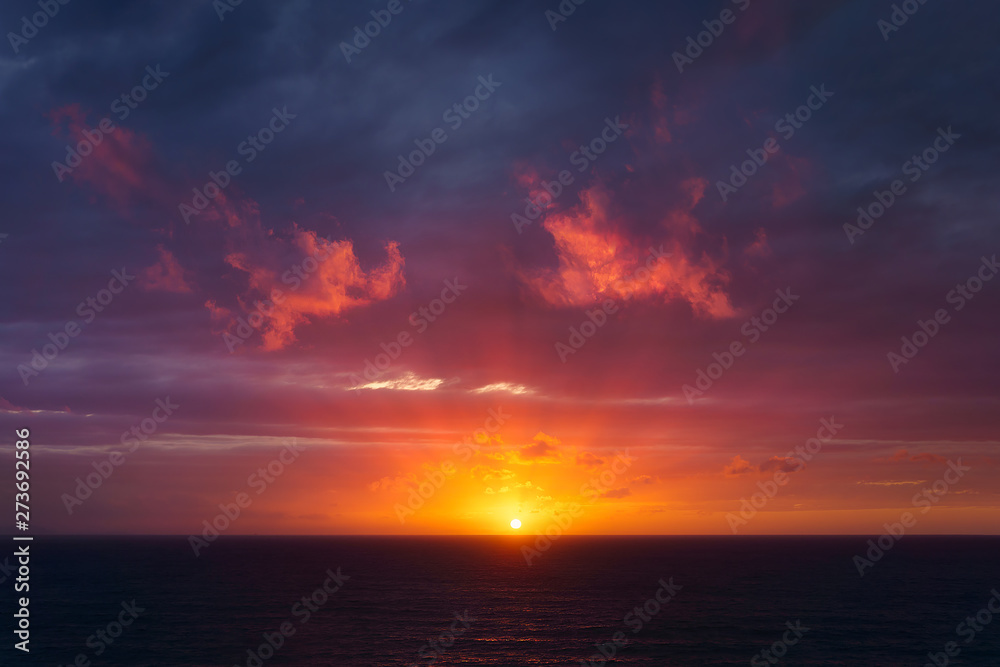 beautiful red dusk over the sea with sun rays