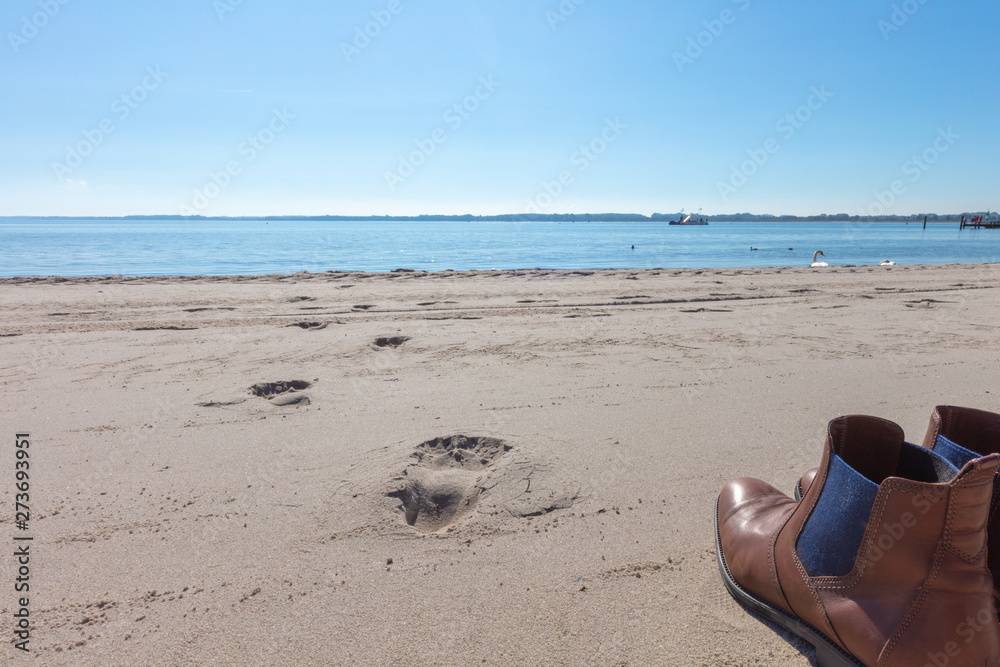 a pair of shoes standing on the beach a pair of shoes standing on the beach