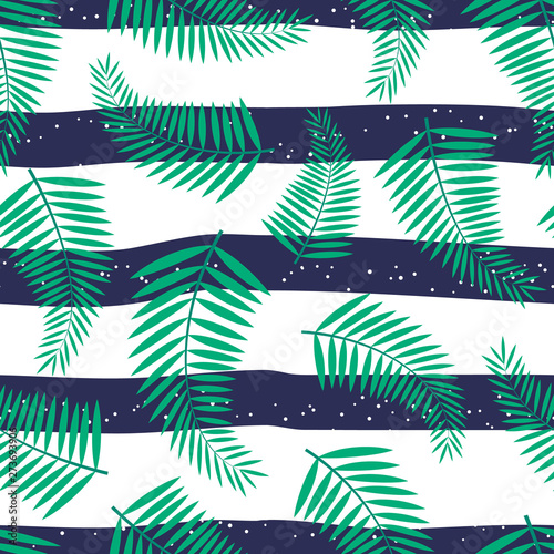 Seamless pattern with tropical leaves of palm on striped background. For wallpapers, decoration, invitation, fabric, textile and print, web page background, gift and wrapping paper.