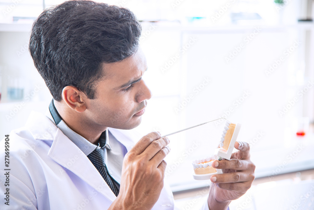 Asian man scientist, researcher, technician, dentist or student conducted research or experiment or diagnose by using scientific, medical equipment or device in clinic, laboratory or hospital Asian man scientist, researcher, technician, dentist or student conducted research or experiment or diagnose by using scientific, medical equipment or device in clinic, laboratory or hospital