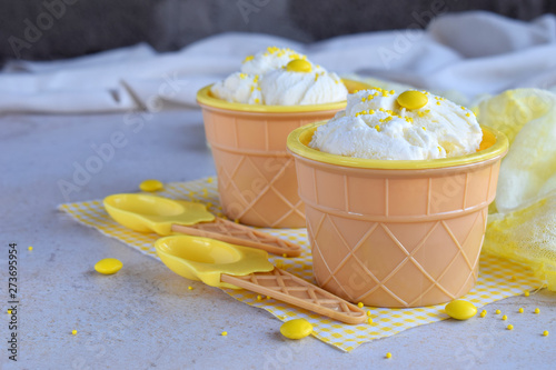 Homemade vanilla ice cream on marble background. White frozen delicious dessert in individual jello vase.
