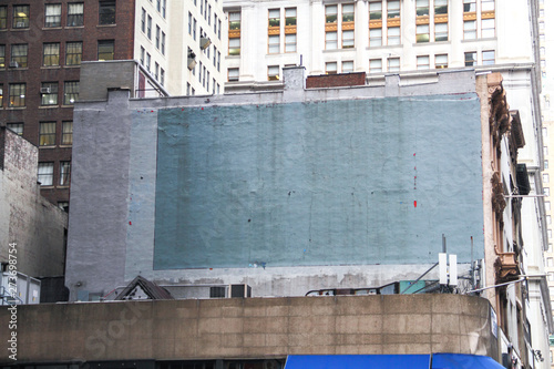 Side of a building in New York with painted-over advert space