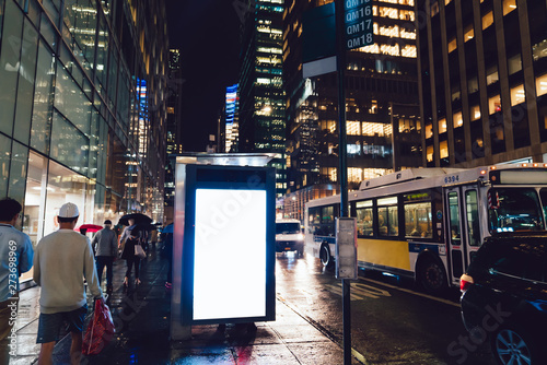 Canvas Print Bus station billboard in rainy night with blank copy space screen for advertisin