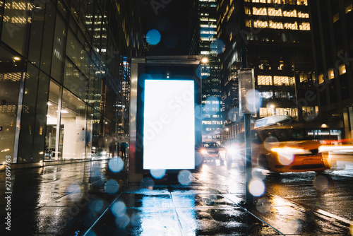 Photography Bus station billboard in rainy night with blank copy space screen for advertisin