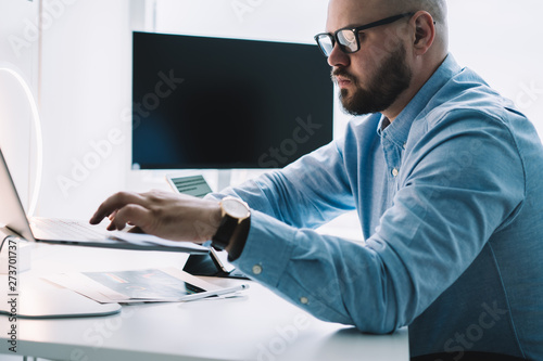 Adult professional man using laptop