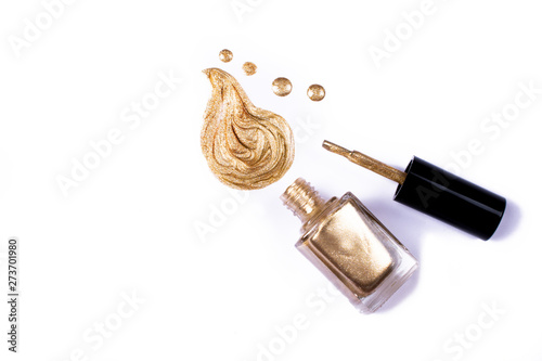 Golden nail polish isolated on white.