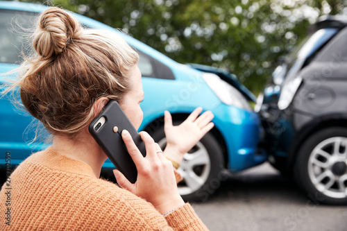 Female Motorist Involved In Car Accident Calling Insurance Company Or Recovery Service