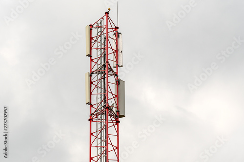 Telecommunication tower on cloudy sky