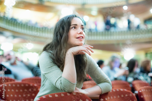 Surprised woman enjoying theatre performance photo