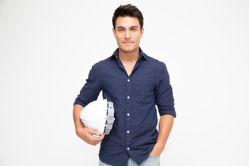 Handsome man industrial engineer holding a white helmet under his arm isolated on white background