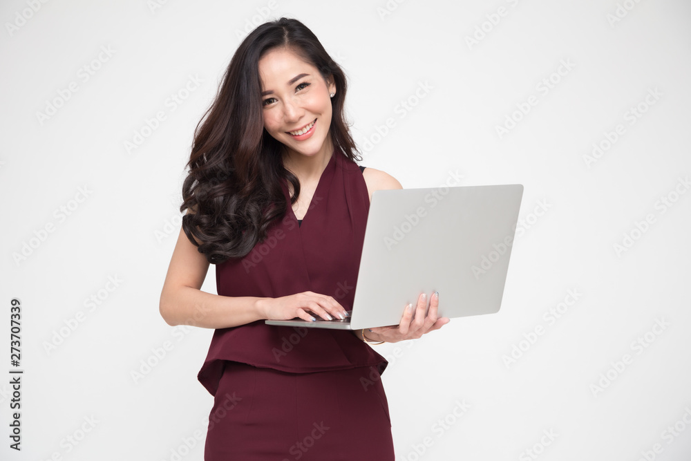 Portrait of an excited Asian woman holding notebook computer on white background, Happiness female model Portrait of an excited Asian woman holding notebook computer on white background, Happiness female model