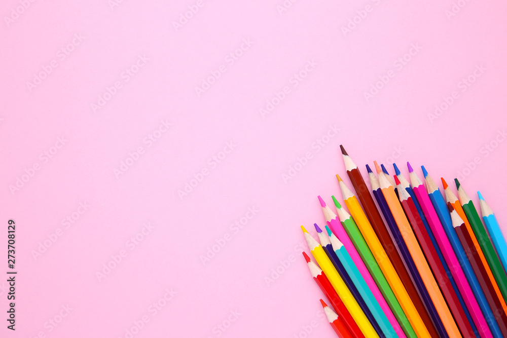 Many different colored pencils on pink background Many different colored pencils on pink background