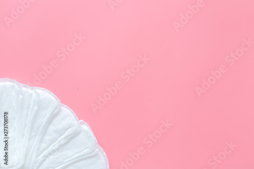 Menstrual period concept with sanitary pads on pink background top view mockup