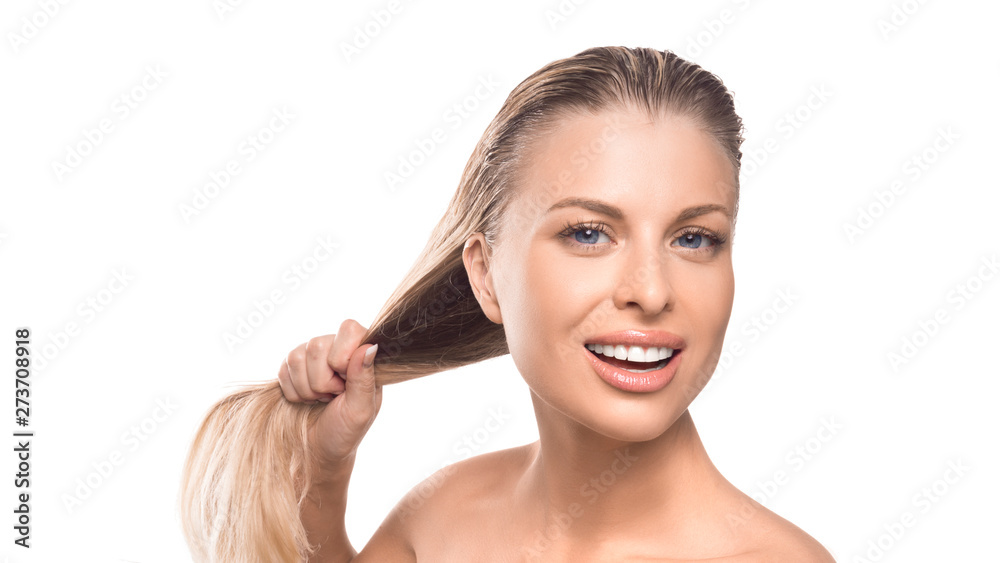 A woman with wet hair is smiling on a white background. Strength of hair concept