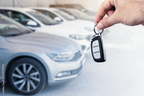 Man's hand holding car key.Automobile rent or leasing concept.