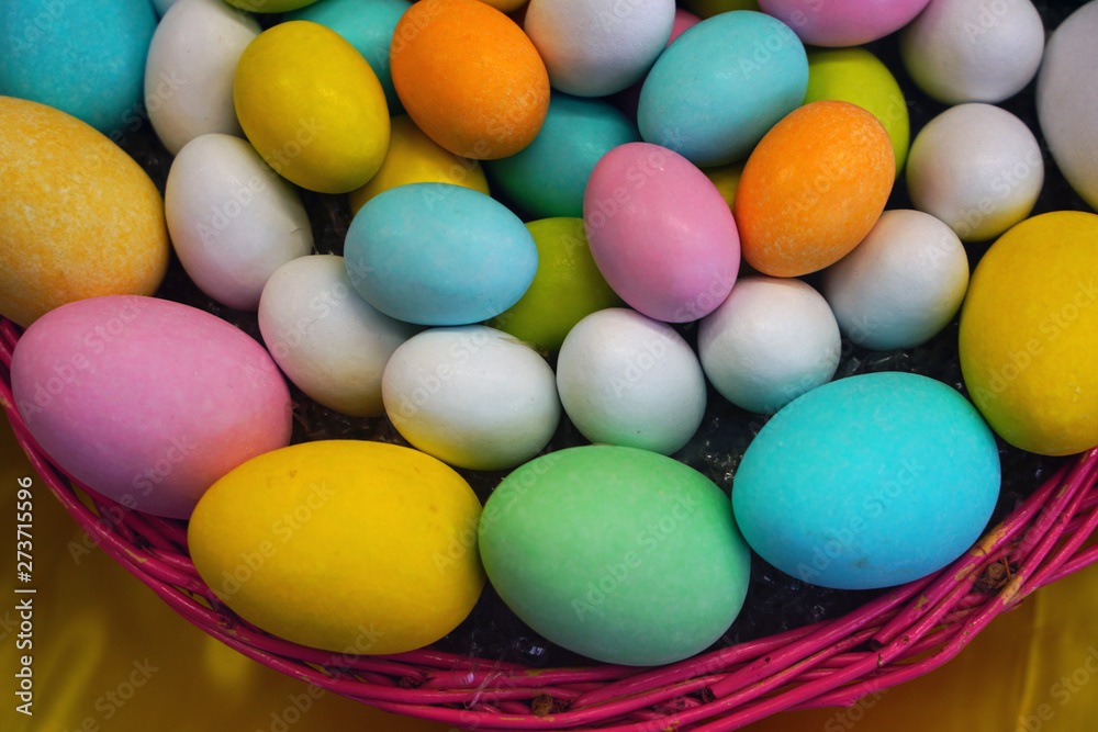 Basket of colorful Easter eggs chocolate candies Basket of colorful Easter eggs chocolate candies