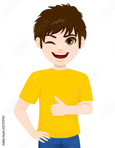 Young teenager boy winking and making thumbs up positive hand sign gesture