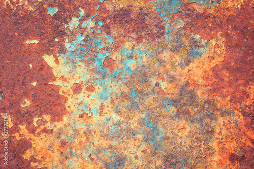 Bright rich colors of old grunge cracked blue weathered wall paint peeling off red rusted metal sheet. Textured background for posters and bloggers