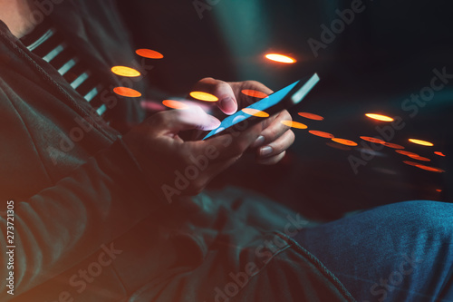 Woman texting on mobile phone in car at night