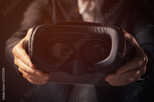 Businesswoman innovator offering VR goggles headset
