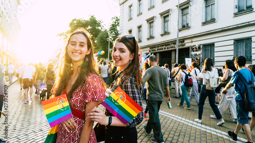Canvas Print Sofia / Bulgaria - 10 June 2019: smiling Girls in LGBT parade with rainbow flag in the street