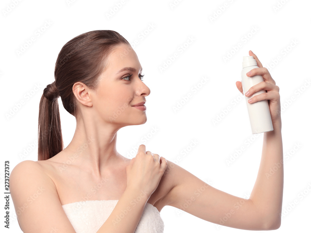 Young woman applying thermal water on face against white background. Cosmetic product Young woman applying thermal water on face against white background. Cosmetic product