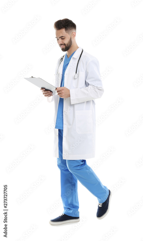 Young male doctor in uniform with clipboard isolated on white Young male doctor in uniform with clipboard isolated on white