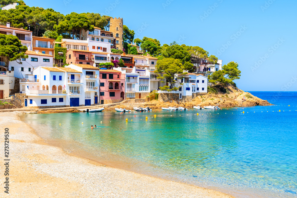 Fototapeta premium Colorful houses in sea bay with beach in Sa Tuna coastal village, Costa Brava, Spain