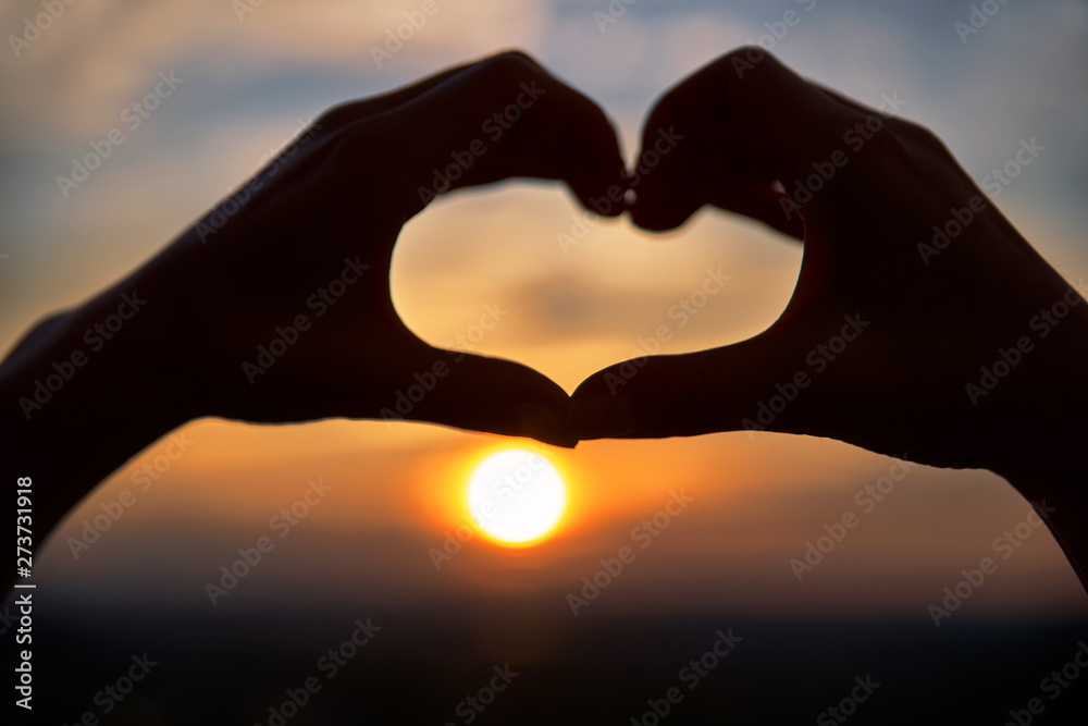 Concept or conceptual woman hands in love, symbol of heart over Montreal background. Heart shape making of hands against bright sunset and sunny golden Concept or conceptual woman hands in love, symbol of heart over Montreal background. Heart shape making of hands against bright sunset and sunny golden