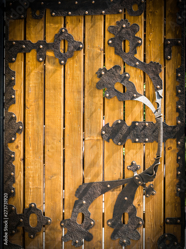 Wooden Gate With Wrought Iron Elements 