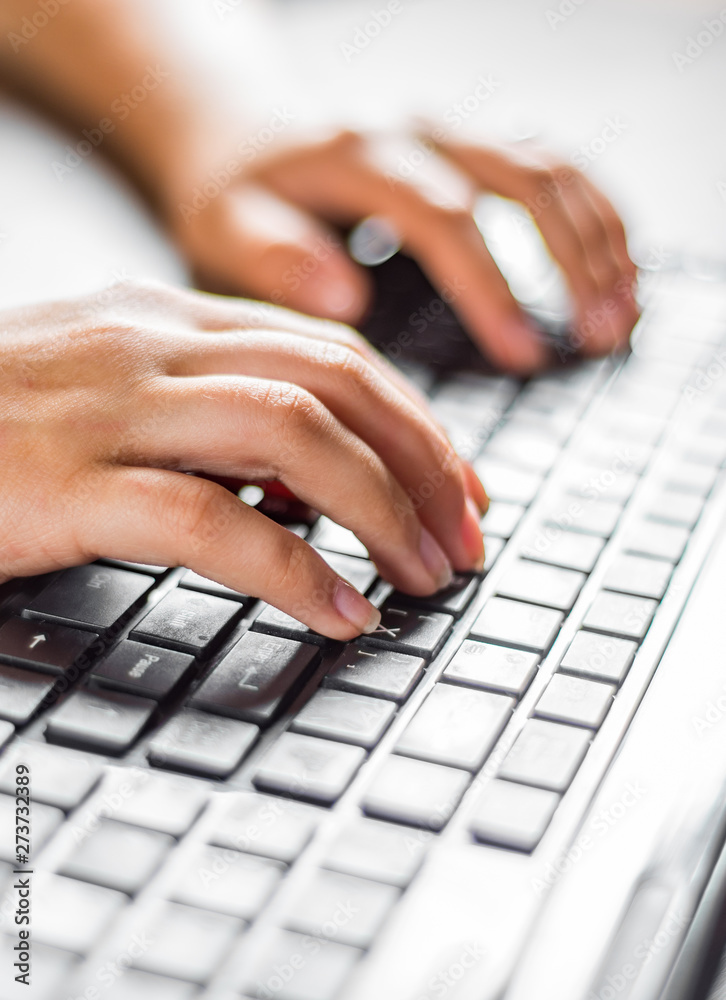Woman working at home office hand on keyboard close up on wooden table background Woman working at home office hand on keyboard close up on wooden table background
