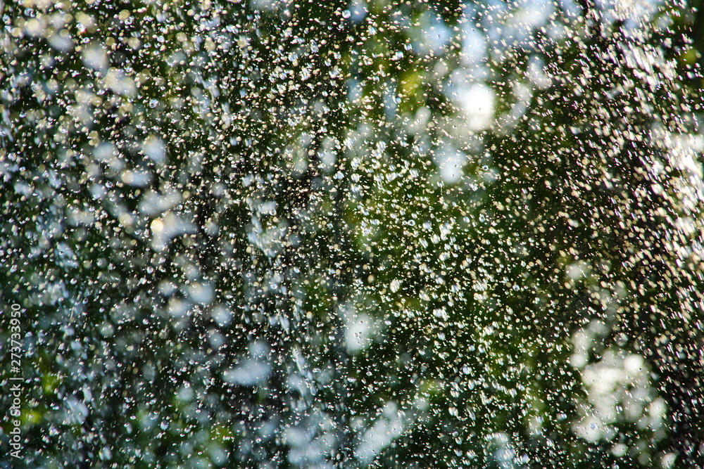 Fototapeta premium abstract background water drops fountain splashes glare from summer sun