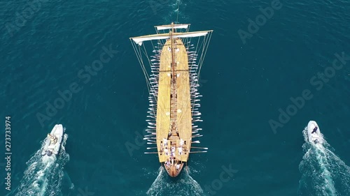 Aerial drone video of Ancient Greek warship full scale replica Trireme arriving in port of Faliro, Attica, Greece photo