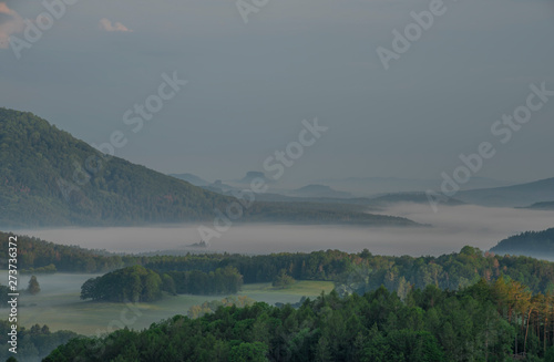 Fototapeta Naklejka Na Ścianę i Meble -  View from Jehla hill over Ceska Kamenice town in spring misty morning