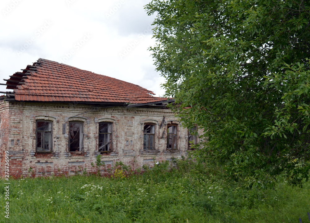 old abandoned non-residential wooden and brick houses in forested villages