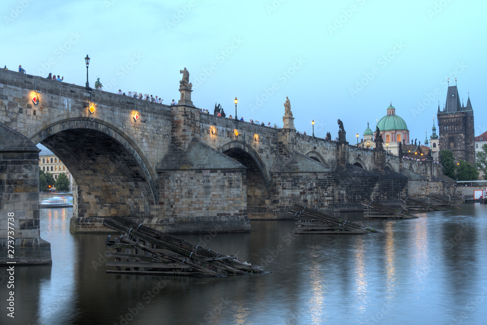 View on eastern side of Charles Bridge with tower and dome of Clementinum in Prague, Czech Republic 