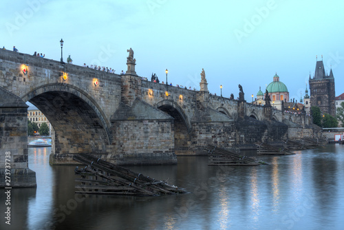 View on eastern side of Charles Bridge with tower and dome of Clementinum in Prague, Czech Republic 