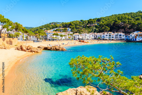 Stunning sandy beach and azure blue water of sea bay in Tamariu seaside town, Costa Brava, Spain