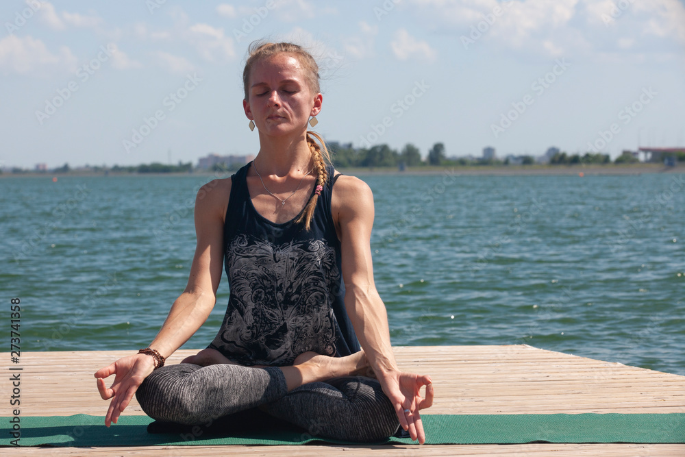 Fototapeta premium Meditation. young woman sitting in the lotus position