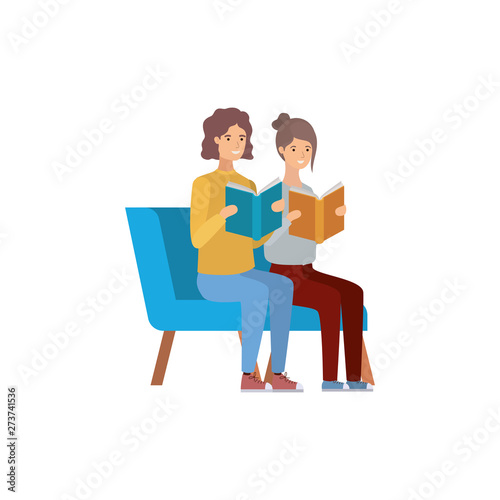 couple sitting on chair with book in hands © grgroup